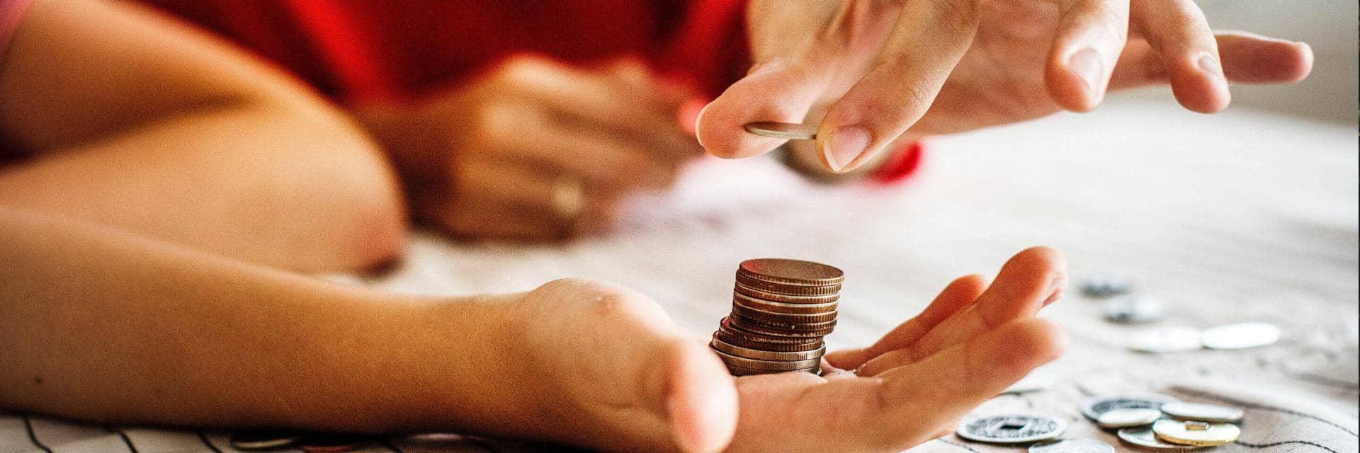  A woman and a child stack up coins on a table